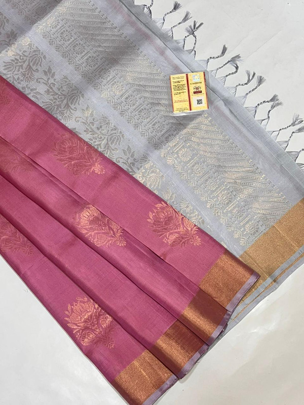 Pure Kanchipuram Saree in Baby Pink colour along with Zari work Design in the full body of the saree with Greyish Colour Pallu with Golden Zari Border.
